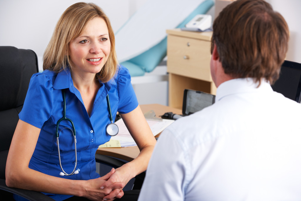 A General Practitioner holding a consultation with a patient